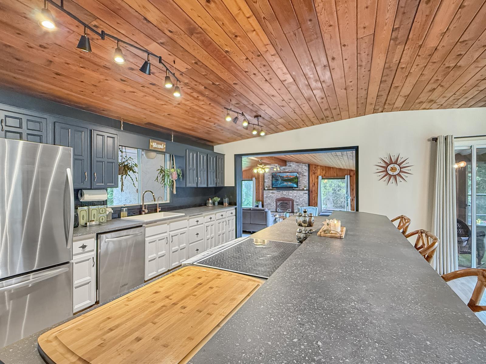 Renovated kitchen with a large island and wood ceilings